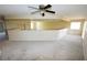 Large loft area with neutral walls, carpet, and a ceiling fan offering a flexible space at 5808 Amber Station Ave, Las Vegas, NV 89131