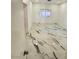 Modern bedroom with marble flooring, large window, and closet at 6022 Highland Gardens Dr, North Las Vegas, NV 89031
