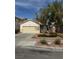 Charming single-story home featuring a well-maintained front yard and attached two-car garage at 6022 Highland Gardens Dr, North Las Vegas, NV 89031