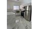 Kitchen featuring stainless steel appliances, marble countertops, and modern fixtures at 6022 Highland Gardens Dr, North Las Vegas, NV 89031