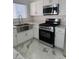 Modern kitchen featuring stainless steel appliances, sleek white cabinets, and marble countertops at 6022 Highland Gardens Dr, North Las Vegas, NV 89031
