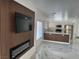 Open-concept living room, highlighting the modern electric fireplace and stunning marble floors at 6022 Highland Gardens Dr, North Las Vegas, NV 89031