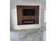 Modern living room showcasing an electric fireplace, flat screen tv and marble floors at 6022 Highland Gardens Dr, North Las Vegas, NV 89031