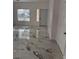 New marble floors, a large window and a modern light fixture provide ample lighting in this bright living area at 6022 Highland Gardens Dr, North Las Vegas, NV 89031