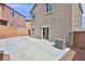 Backyard with a large concrete patio area, block wall fencing, and convenient access door at 6207 Hamilton Ave, Las Vegas, NV 89122