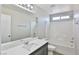 This bathroom features a large mirror over the sink and a shower and tub combo at 6207 Hamilton Ave, Las Vegas, NV 89122