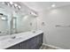 This bathroom features a large mirror over the sink and dual vanity lights at 6207 Hamilton Ave, Las Vegas, NV 89122