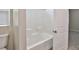 This bathroom features a shower and tub combo adjacent to a toilet and open doorway at 6207 Hamilton Ave, Las Vegas, NV 89122