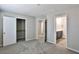 This bedroom features gray carpet and open doorways to a closet and bathroom at 6207 Hamilton Ave, Las Vegas, NV 89122