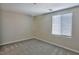 This bedroom includes gray carpet and a window with blinds at 6207 Hamilton Ave, Las Vegas, NV 89122