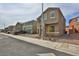 Two-story tan home with a two car garage and manicured front yard featuring easy to care for landscaping at 6207 Hamilton Ave, Las Vegas, NV 89122
