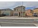 Two-story tan home with a two car garage and manicured front yard featuring easy to care for landscaping at 6207 Hamilton Ave, Las Vegas, NV 89122