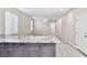 Open concept kitchen featuring light granite countertops and gray cabinets at 6207 Hamilton Ave, Las Vegas, NV 89122