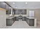 Spacious kitchen featuring granite countertops, gray cabinets, and stainless steel appliances at 6207 Hamilton Ave, Las Vegas, NV 89122