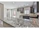 Stylish kitchen with granite counters, stainless appliances, and convenient access to the outdoor patio at 6207 Hamilton Ave, Las Vegas, NV 89122