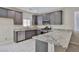 Well-lit kitchen with stainless steel appliances, gray cabinets and beautiful granite countertops at 6207 Hamilton Ave, Las Vegas, NV 89122