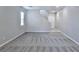 Spacious living room featuring gray carpet, white walls and a staircase at 6207 Hamilton Ave, Las Vegas, NV 89122