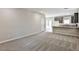 Open living room with neutral carpet that opens into the kitchen at the back of the home at 6207 Hamilton Ave, Las Vegas, NV 89122
