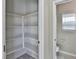 Walk-in pantry with white shelving and access to a half bath with a pedestal sink at 6207 Hamilton Ave, Las Vegas, NV 89122