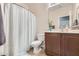 This bathroom includes a shower and tub combination, a toilet, and a vanity with cabinets at 6446 Button Quail St, North Las Vegas, NV 89084