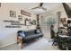 This bedroom features a ceiling fan and sports memorabilia adorning the walls at 6446 Button Quail St, North Las Vegas, NV 89084