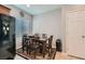 Dining area adjacent to kitchen with a table, six chairs and a decorative rug at 6446 Button Quail St, North Las Vegas, NV 89084