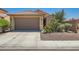 Charming single-story home with a two-car garage, desert landscaping, and a well-maintained front yard at 6446 Button Quail St, North Las Vegas, NV 89084