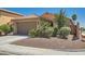Well-maintained single-story home with a two-car garage, desert landscaping, and a tile roof at 6446 Button Quail St, North Las Vegas, NV 89084