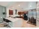 Stylish kitchen with granite countertops, stainless steel appliances, and a breakfast bar overlooking the dining area at 6446 Button Quail St, North Las Vegas, NV 89084