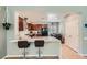 Modern kitchen with stainless steel appliances, white countertops, dark cabinetry, and a breakfast bar at 6446 Button Quail St, North Las Vegas, NV 89084