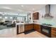 Modern kitchen with stainless steel appliances, light countertops, and open concept to living area at 6446 Button Quail St, North Las Vegas, NV 89084