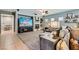 Cozy living room featuring tile and carpet flooring, a fireplace, and ample natural light at 6446 Button Quail St, North Las Vegas, NV 89084