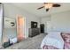 Spacious main bedroom with gray furniture, plush carpeting, and a bright, open feel at 6446 Button Quail St, North Las Vegas, NV 89084