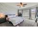 Main bedroom featuring a brick accent wall, neutral color palette, and plush carpeting at 6446 Button Quail St, North Las Vegas, NV 89084