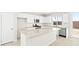 Bright kitchen with stainless steel appliances, white cabinets, and a spacious central island at 66 Via Montoro, Henderson, NV 89015