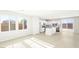 A bright, airy living room showcasing the kitchen with stainless steel appliances at 66 Via Montoro, Henderson, NV 89015