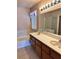 Well-lit bathroom with double sink vanity and shower over tub at 6600 Silver Penny Ave, Las Vegas, NV 89108