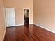 Spacious bedroom features neutral walls and wood floors at 6600 Silver Penny Ave, Las Vegas, NV 89108