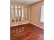 Bright bedroom features stylish vertical mirrors and gleaming hardwood floors at 6600 Silver Penny Ave, Las Vegas, NV 89108