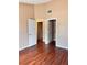 Bedroom with hardwood floors and multiple doorways offering seamless transitions at 6600 Silver Penny Ave, Las Vegas, NV 89108