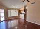 Bright dining area with hardwood floors, a ceiling fan, and a view into the kitchen at 6600 Silver Penny Ave, Las Vegas, NV 89108