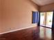 Bright living room features wood floors, access to the backyard, and neutral wall color at 6600 Silver Penny Ave, Las Vegas, NV 89108