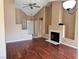 Inviting living room with a corner fireplace, hardwood floors, and neutral wall colors at 6600 Silver Penny Ave, Las Vegas, NV 89108