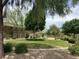Lush green backyard with mature trees, manicured lawn, and attractive landscaping at 676 Otter Brook St, Henderson, NV 89011