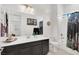 Well-lit bathroom features double vanity, modern fixtures, and shower-tub combo at 676 Otter Brook St, Henderson, NV 89011