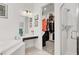 Bathroom featuring vanity, corner tub, glass shower, and closet view at 676 Otter Brook St, Henderson, NV 89011