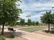 Outdoor bocce ball courts with manicured landscaping, benches, and shaded areas for relaxing play at 676 Otter Brook St, Henderson, NV 89011