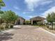 Scenic community center with a circular driveway, lush landscaping, and clear blue skies at 676 Otter Brook St, Henderson, NV 89011