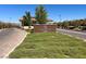 Inviting entrance to Heritage by Lennar with lush green landscaping and clear blue skies at 676 Otter Brook St, Henderson, NV 89011