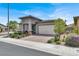 Beautiful single-story home with well-manicured landscaping and a brick driveway at 676 Otter Brook St, Henderson, NV 89011